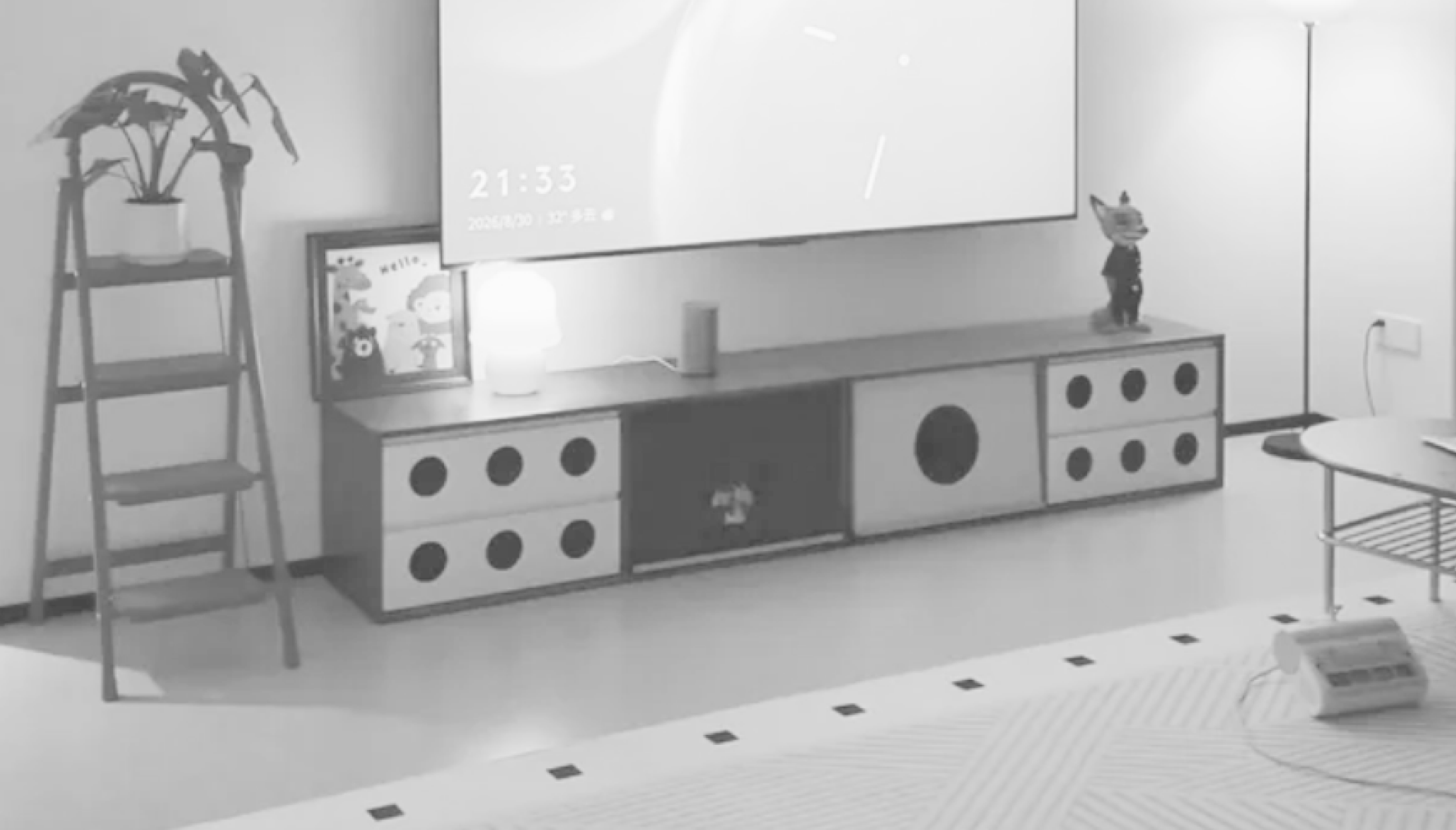 A quiet living room with a projector screen and striped rug.
